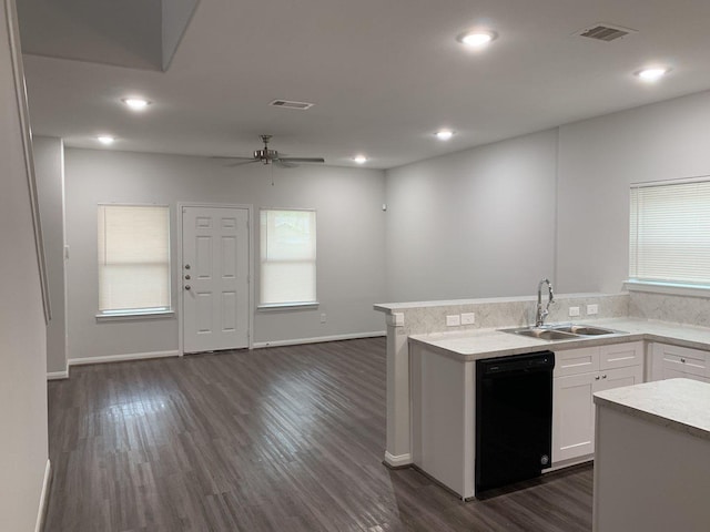 kitchen with white cabinetry, light countertops, black dishwasher, and visible vents