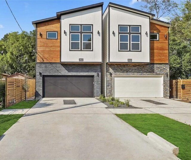 3462 Mount Pleasant St, Houston, TX 77021 - modern home featuring stone siding, concrete driveway, an attached garage, and fence