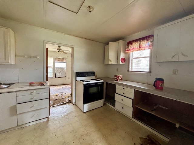 100 Upton Ln, Brazoria, TX 77422 - kitchen with light countertops, white cabinets, electric stove, and light floors