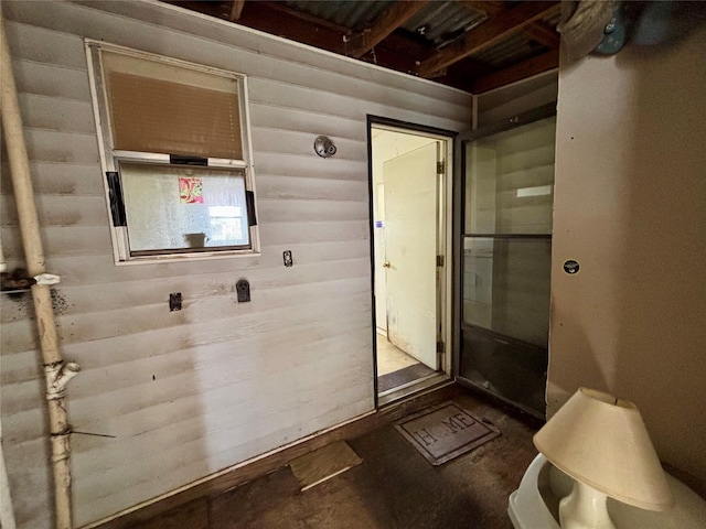 100 Upton Ln, Brazoria, TX 77422 - bathroom featuring unfinished concrete floors and wood walls