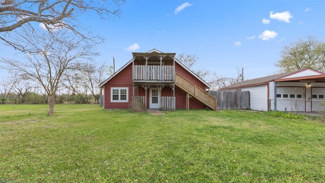 810 Robinson Rd, La Porte, TX 77571 - back of house featuring a garage, stairs, a yard, and fence