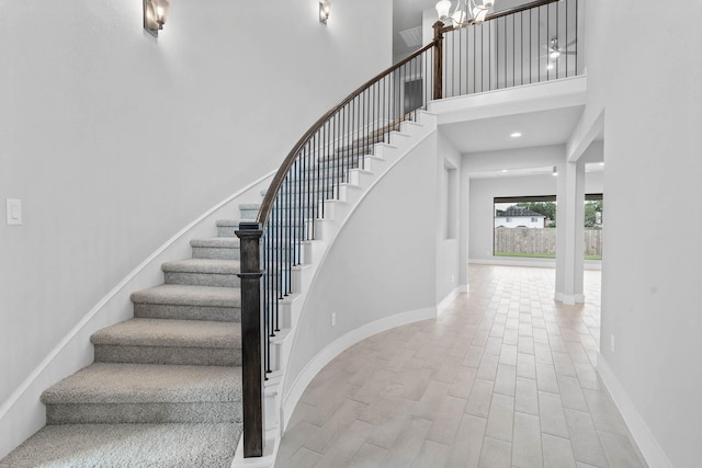 23507 Persimmon Creek Ln, Katy, TX 77493 - stairway with a towering ceiling, wood finished floors, and a chandelier