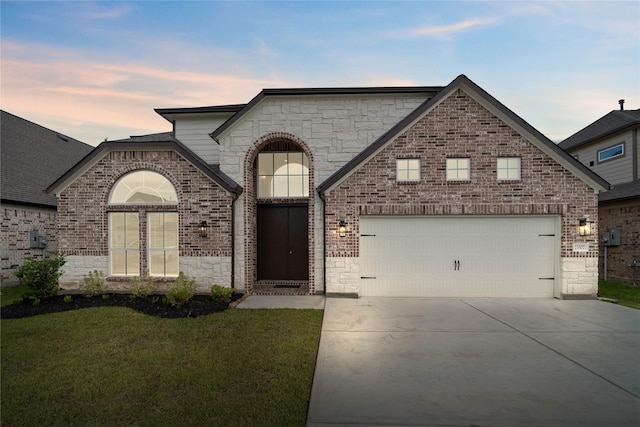 23507 Persimmon Creek Ln, Katy, TX 77493 - french country inspired facade with an attached garage, concrete driveway, brick siding, and stone siding