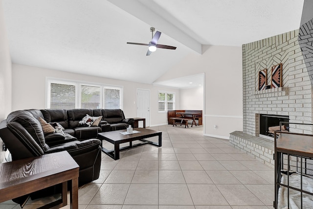 living area featuring light tile patterned flooring, baseboards, a brick fireplace, ceiling fan, and vaulted ceiling with beams