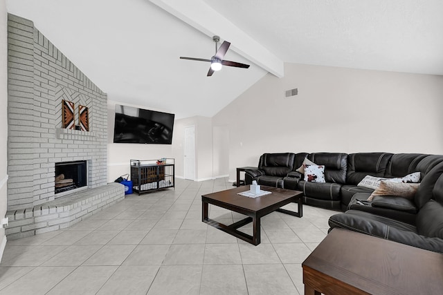living room featuring light tile patterned flooring, a fireplace, lofted ceiling with beams, and a ceiling fan