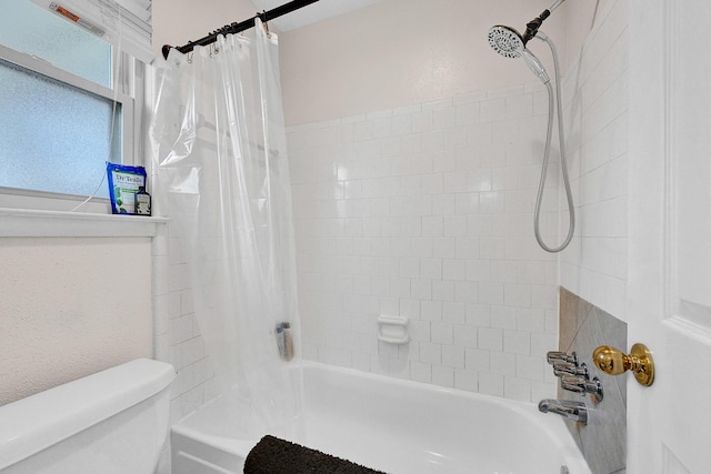 bathroom featuring shower / bathtub combination with curtain and toilet