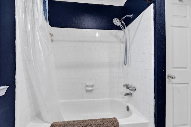 bathroom with a textured wall and shower / tub combo with curtain