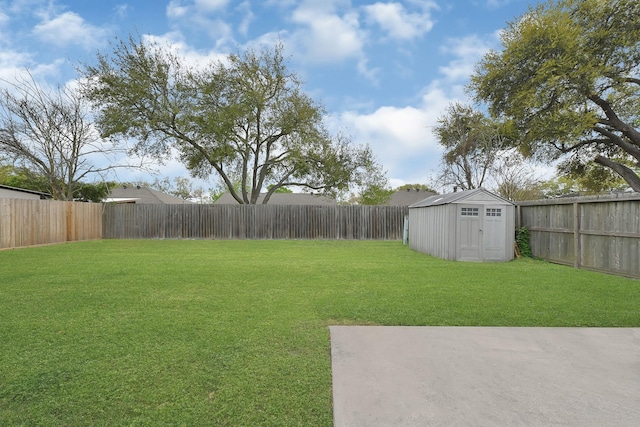 view of yard with a storage unit, a fenced backyard, and an outdoor structure