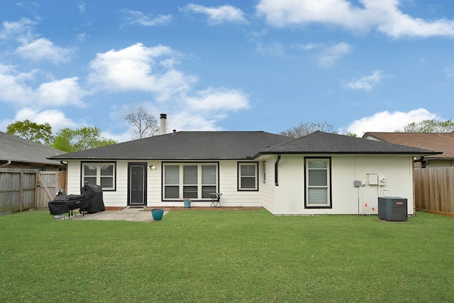 rear view of property with central air condition unit, roof with shingles, a fenced backyard, a yard, and a patio
