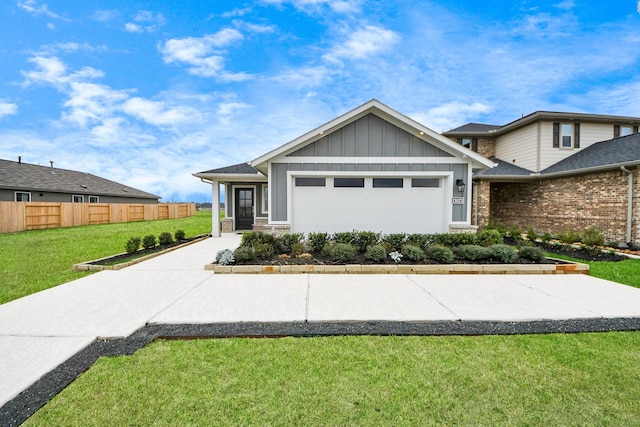 view of front of home featuring board and batten siding, a front lawn, fence, and an attached garage