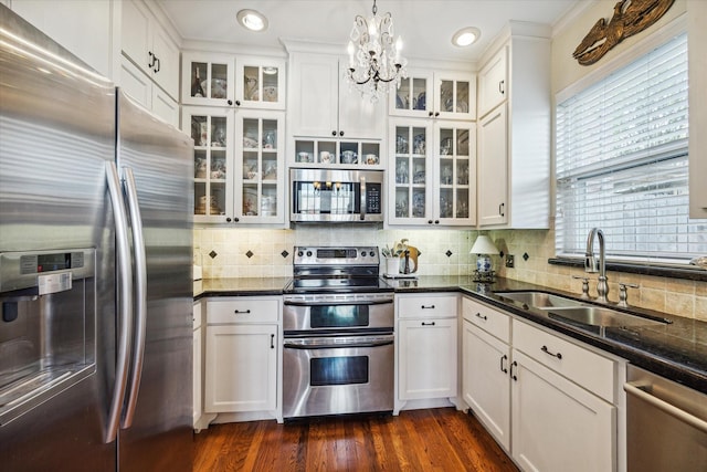 4106 Childress St, Houston, TX 77005 - kitchen featuring pendant lighting, white cabinetry, appliances with stainless steel finishes, a sink, and backsplash