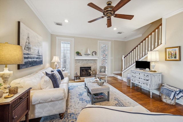 4106 Childress St, Houston, TX 77005 - living area featuring visible vents, a brick fireplace, a ceiling fan, wood finished floors, and stairs