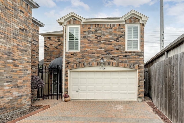 4106 Childress St, Houston, TX 77005 - view of front facade with brick siding, an attached garage, fence, and decorative driveway