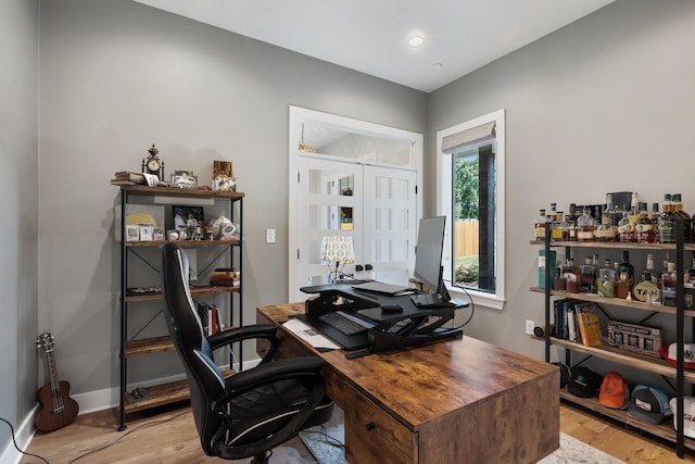 office space featuring light wood finished floors and baseboards