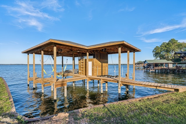 dock area with a water view and boat lift