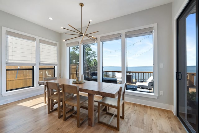 dining space with baseboards, recessed lighting, a chandelier, and light wood-type flooring