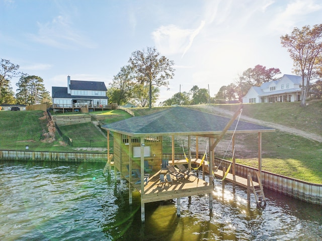 dock area featuring a lawn and a water view