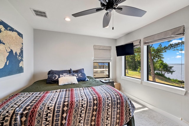 carpeted bedroom with a ceiling fan, visible vents, and recessed lighting