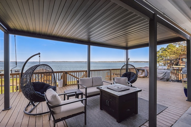 wooden terrace featuring outdoor lounge area and a water view