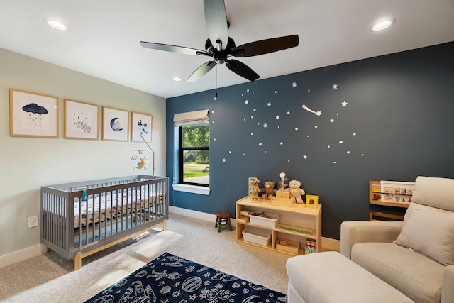 carpeted bedroom featuring a crib, baseboards, and recessed lighting