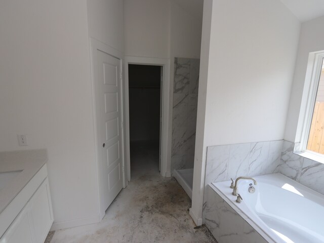 26239 Astral Way, La Marque, TX 77568 - bathroom with vanity, a garden tub, and unfinished concrete flooring