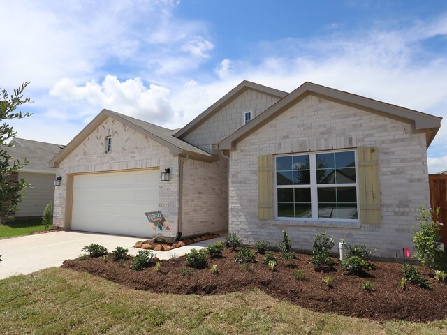 26239 Astral Way, La Marque, TX 77568 - view of front facade featuring an attached garage, driveway, and brick siding