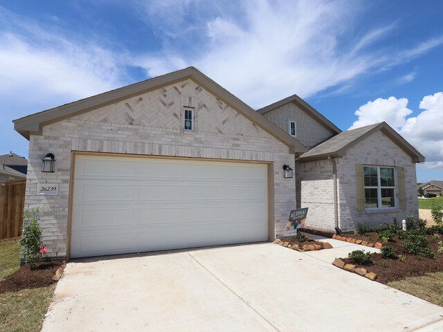 26239 Astral Way, La Marque, TX 77568 - view of front of house with concrete driveway, an attached garage, and brick siding