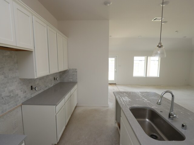26239 Astral Way, La Marque, TX 77568 - kitchen featuring decorative backsplash, white cabinets, and hanging light fixtures