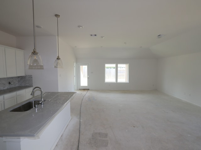 26239 Astral Way, La Marque, TX 77568 - kitchen with lofted ceiling, white cabinets, backsplash, an island with sink, and decorative light fixtures