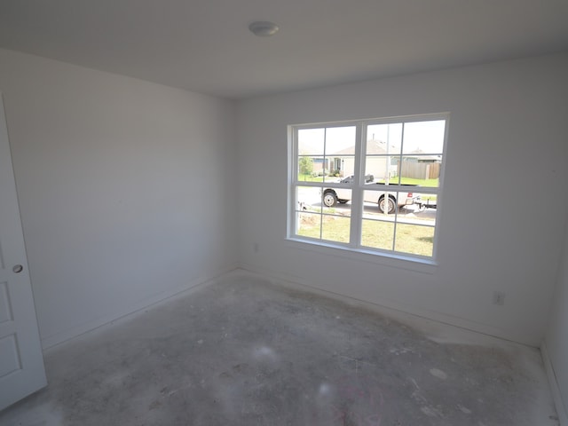 26239 Astral Way, La Marque, TX 77568 - empty room featuring unfinished concrete flooring and baseboards