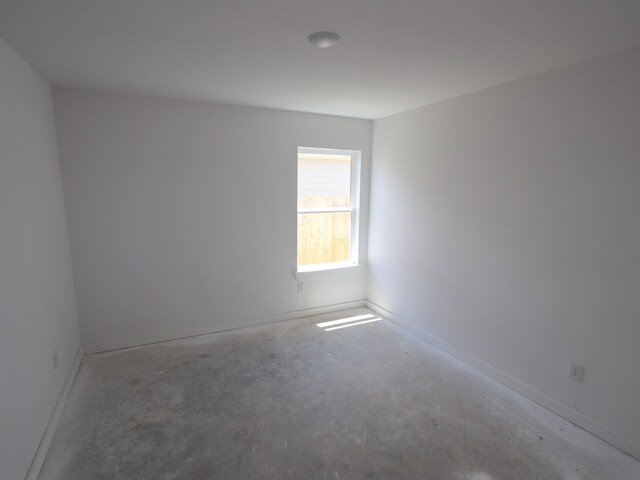 26239 Astral Way, La Marque, TX 77568 - unfurnished room featuring unfinished concrete flooring and baseboards