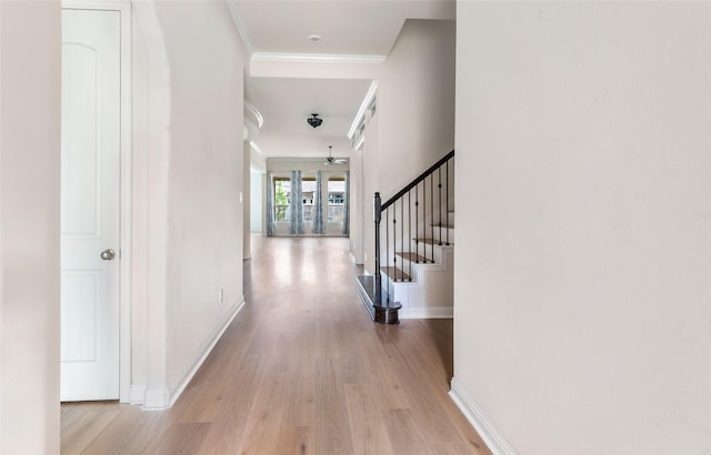 23509 Red Juniper Ln, New Caney, TX 77357 - corridor with ornamental molding, light wood-type flooring, baseboards, and stairs