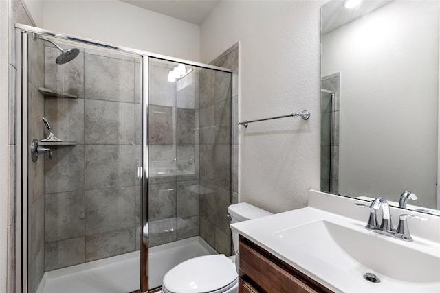 23509 Red Juniper Ln, New Caney, TX 77357 - bathroom with toilet, a shower stall, vanity, and a textured wall