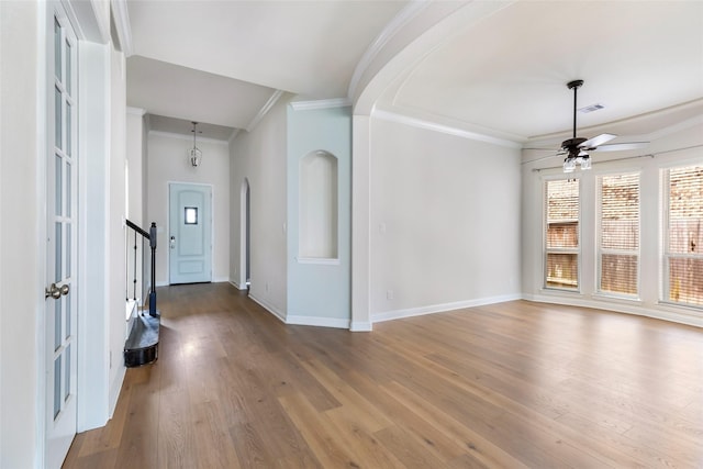 23509 Red Juniper Ln, New Caney, TX 77357 - foyer featuring ornamental molding, baseboards, ceiling fan, wood finished floors, and arched walkways