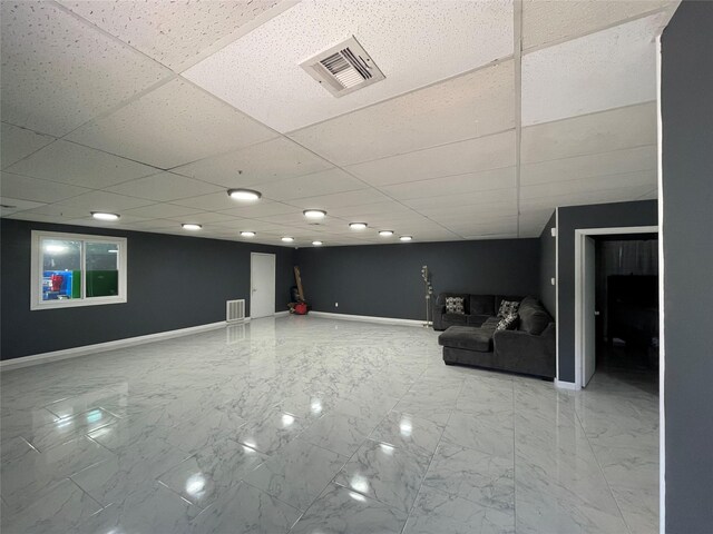 105 S 2nd St, Richmond, TX 77469 - finished basement with baseboards, visible vents, marble finish floor, and a paneled ceiling