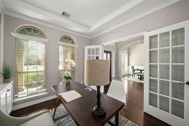 office with visible vents, baseboards, arched walkways, a raised ceiling, and dark wood-style flooring