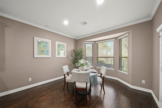 dining area with visible vents, baseboards, dark wood finished floors, and crown molding