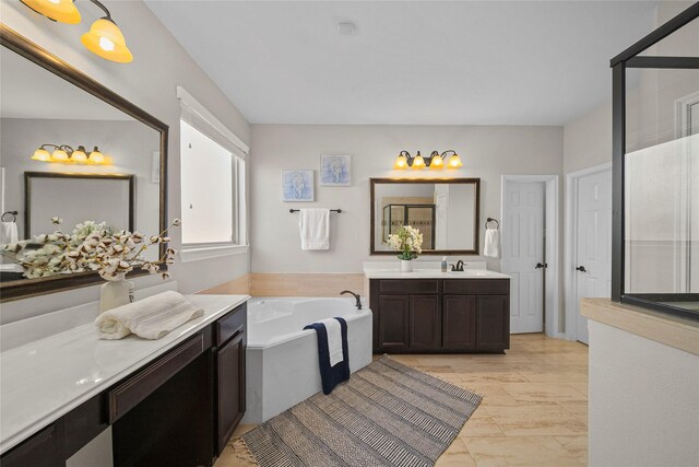 full bath featuring vanity, a bath, and a stall shower