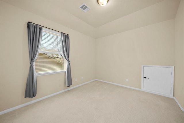 carpeted empty room featuring visible vents and baseboards
