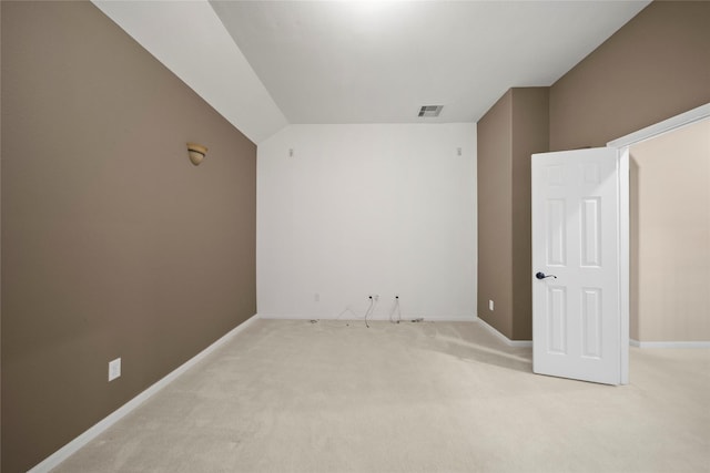 spare room with light colored carpet, visible vents, and baseboards