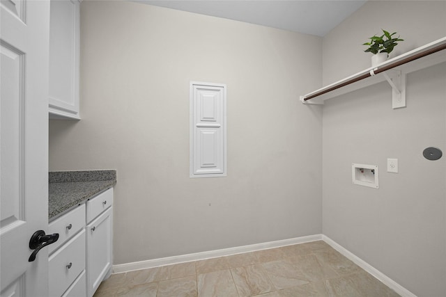 clothes washing area with cabinet space, hookup for a washing machine, and baseboards