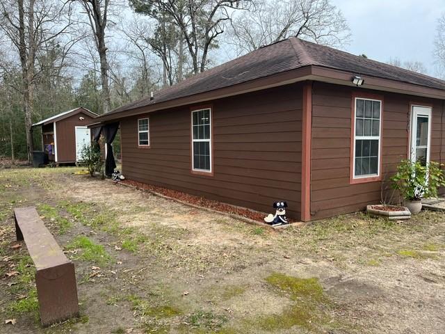 view of home's exterior with an outbuilding