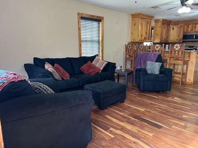 living area featuring ceiling fan and wood finished floors