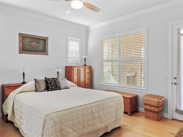 bedroom with baseboards, wood finished floors, a ceiling fan, and ornamental molding