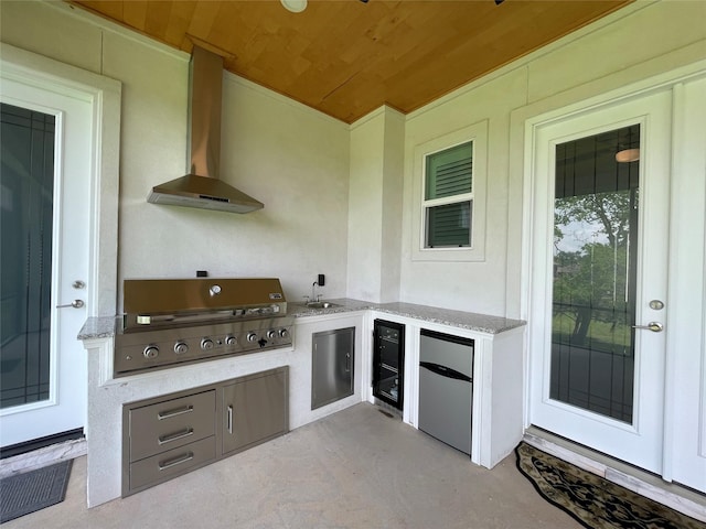 view of patio with exterior kitchen, a sink, a grill, and beverage cooler