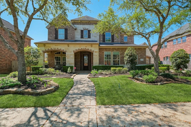 5206 Briarwick Meadow Ln, Sugar Land, TX 77479 - view of front of house featuring a front lawn, brick siding, and stone siding