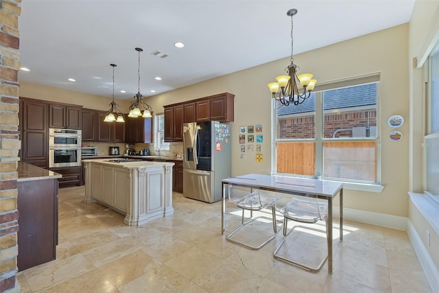5206 Briarwick Meadow Ln, Sugar Land, TX 77479 - kitchen with stainless steel appliances, a chandelier, tasteful backsplash, plenty of natural light, and recessed lighting