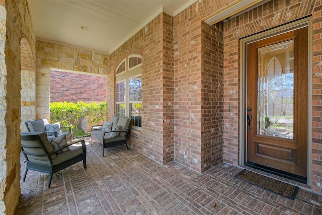 5206 Briarwick Meadow Ln, Sugar Land, TX 77479 - property entrance with brick siding, covered porch, and an outdoor living space