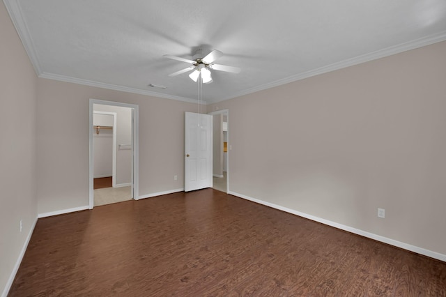 1015 Chickasaw Dr, Montgomery, TX 77316 - unfurnished bedroom featuring dark wood-style floors, crown molding, a walk in closet, and a ceiling fan