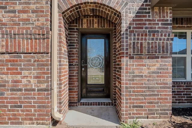 entrance to property with brick siding
